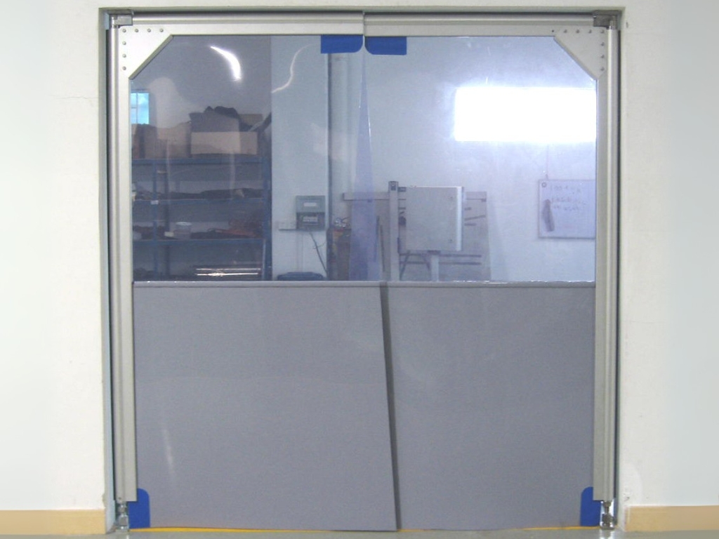 A swing door with a clear top section and a gray bottom section.