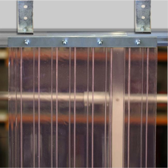 clear ribbed PVC strip curtain mounted with a twin-track metal bracket system for industrial doorway installation